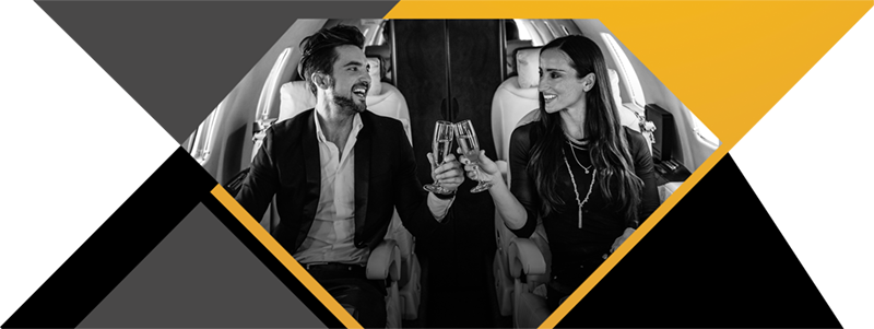 A Couple Toasting Wine And Smiling In A Plane
