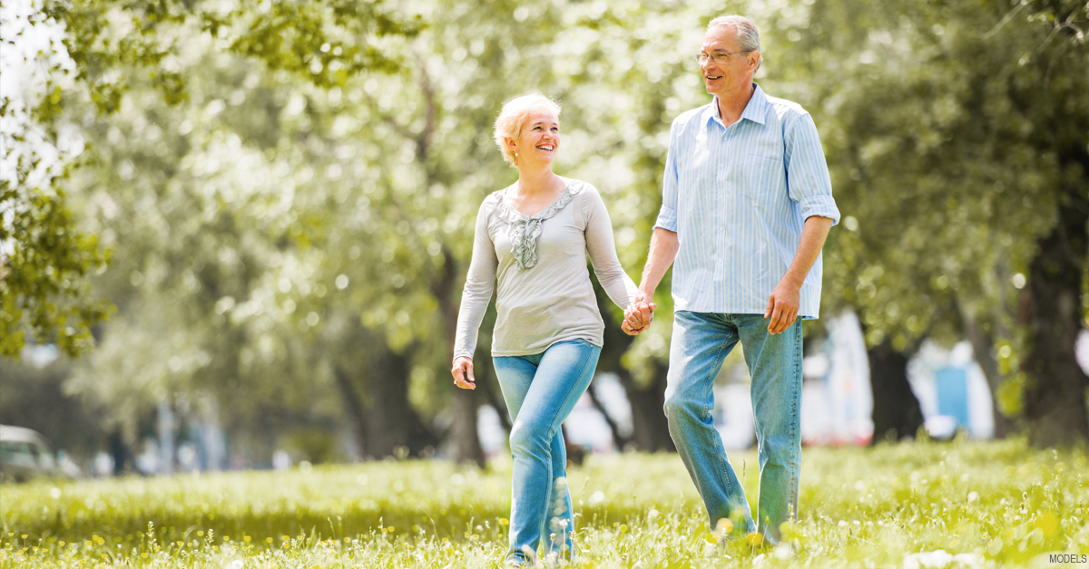 Older couple walking and discussing hormone therapy options